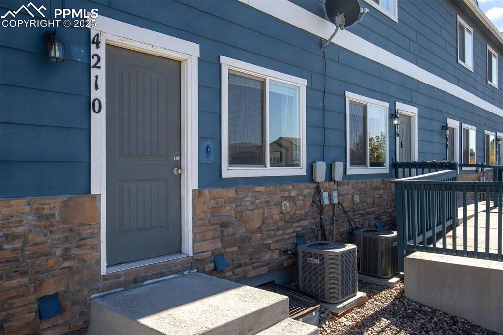 Caption: Entrance to property featuring stone siding