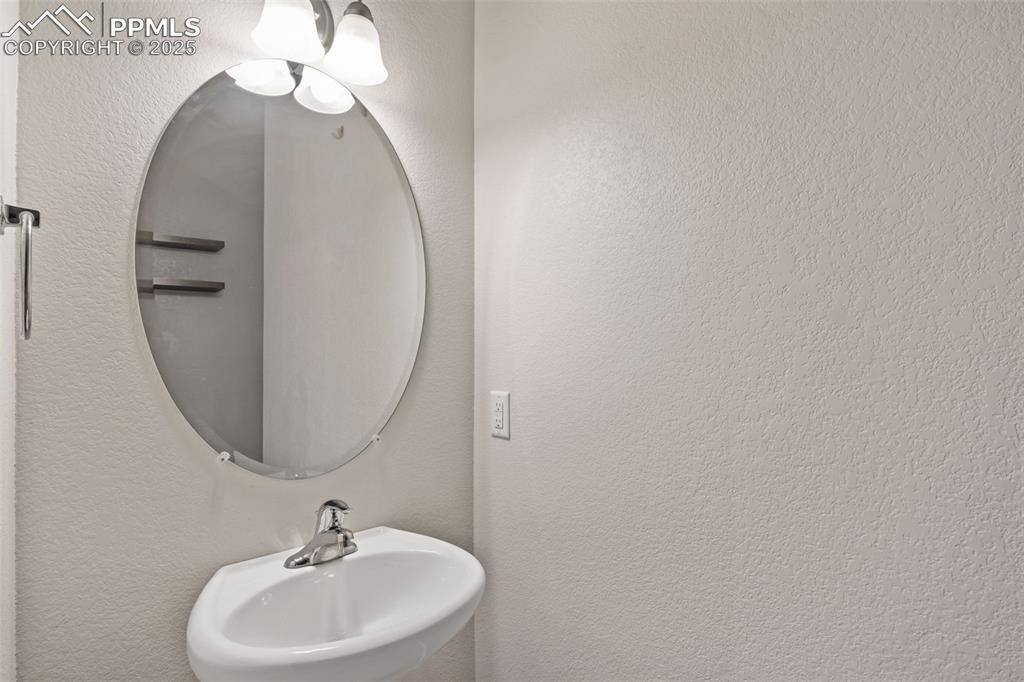 Image 18 of 41: Bathroom featuring a textured wall and a sink