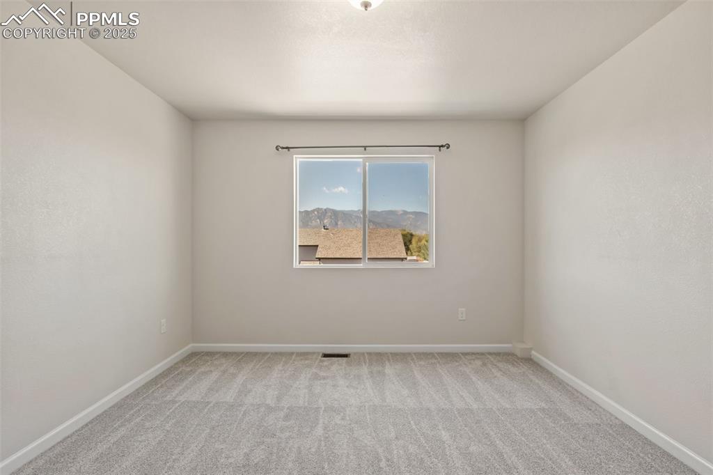Image 25 of 41: Empty room featuring light carpet and baseboards