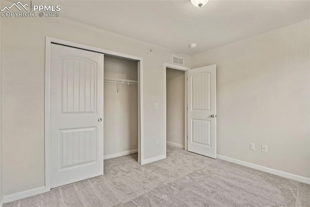 Image 29 of 41: Unfurnished bedroom with light carpet and a closet