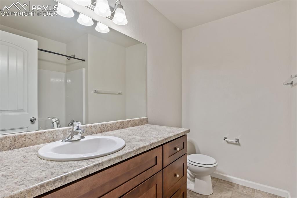 Image 30 of 41: Full bath with vanity, a shower, and light tile patterned floors