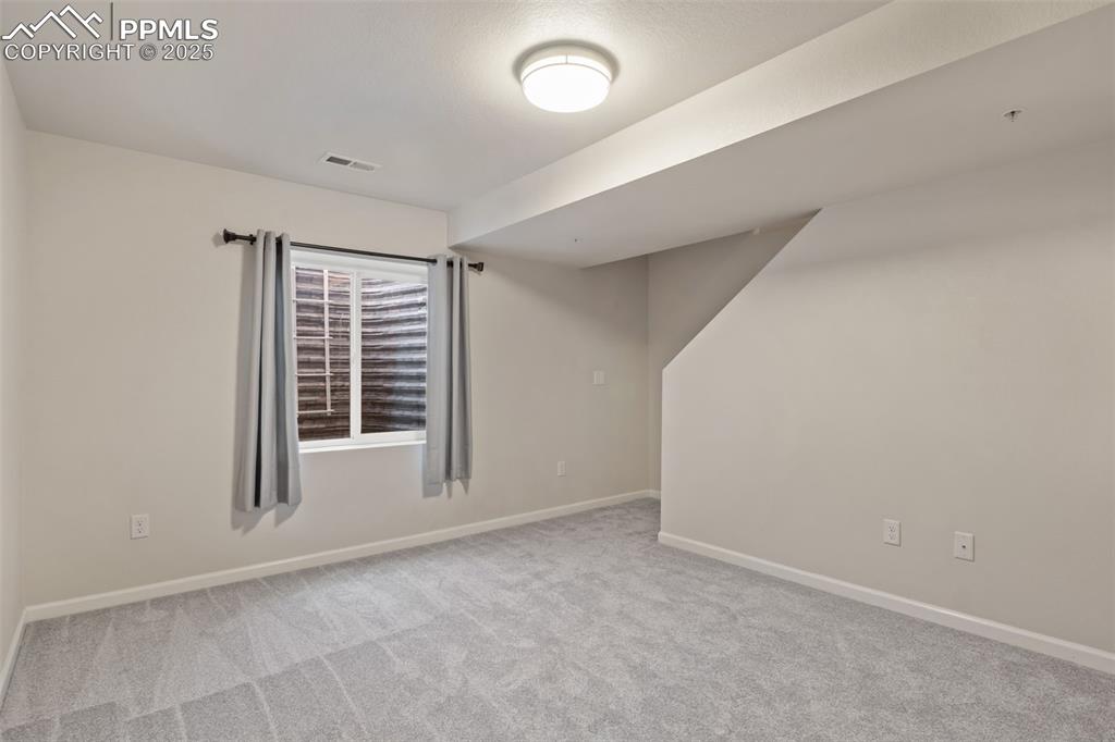 Image 32 of 41: Basement featuring baseboards and light carpet