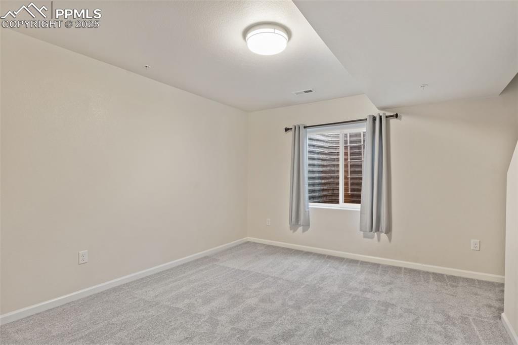 Image 33 of 41: Unfurnished room featuring baseboards and light colored carpet