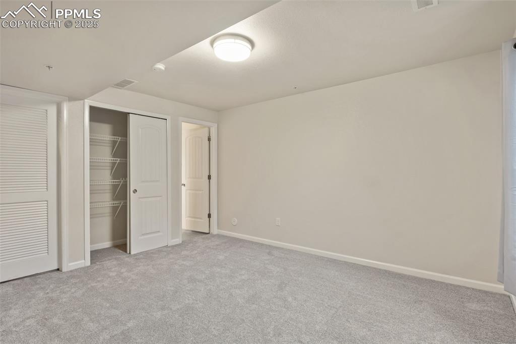 Image 34 of 41: Unfurnished bedroom with a closet and light colored carpet