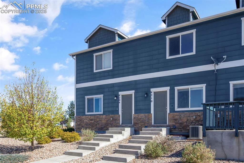 Image 4 of 41: View of front of property with stone siding