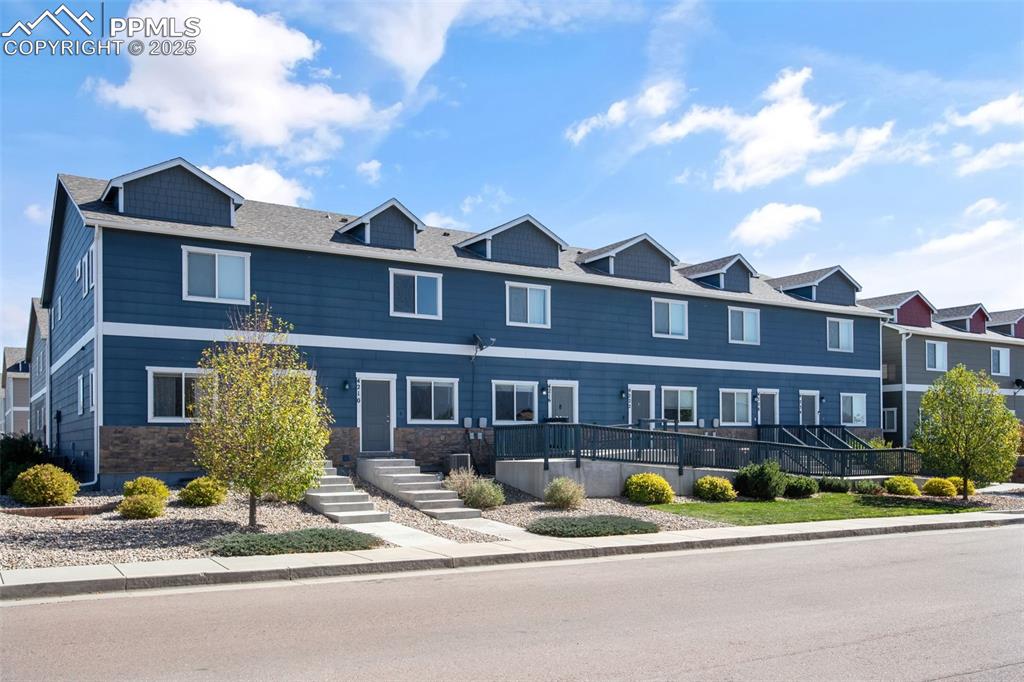 Image 5 of 41: View of front of home featuring stone siding