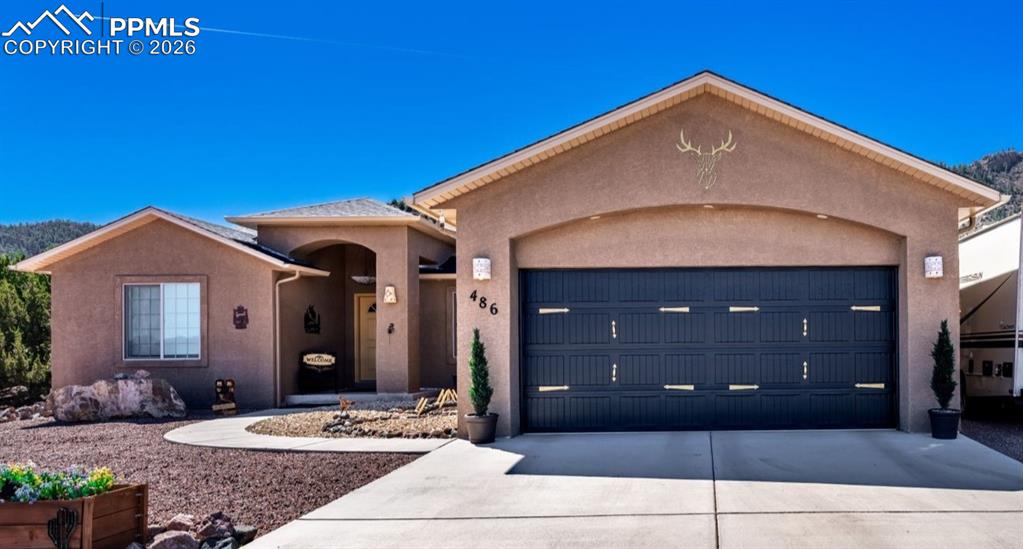 Image 1 of 50: Ranch-style house with driveway, stucco siding, and a garage
