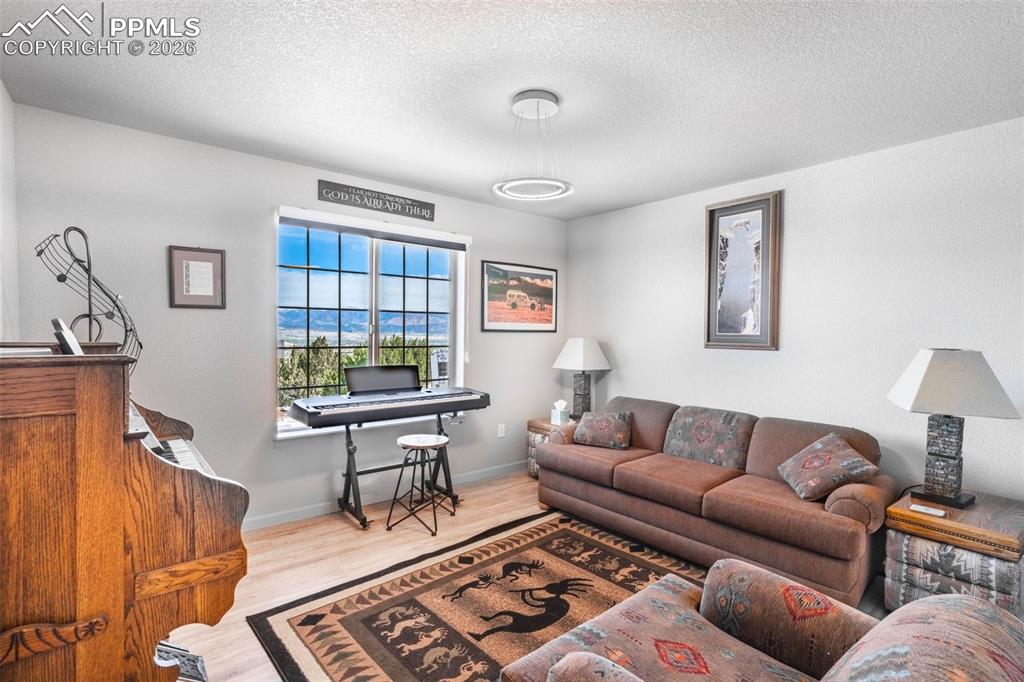Image 10 of 50: Second bedroom facing front of home with mountain views