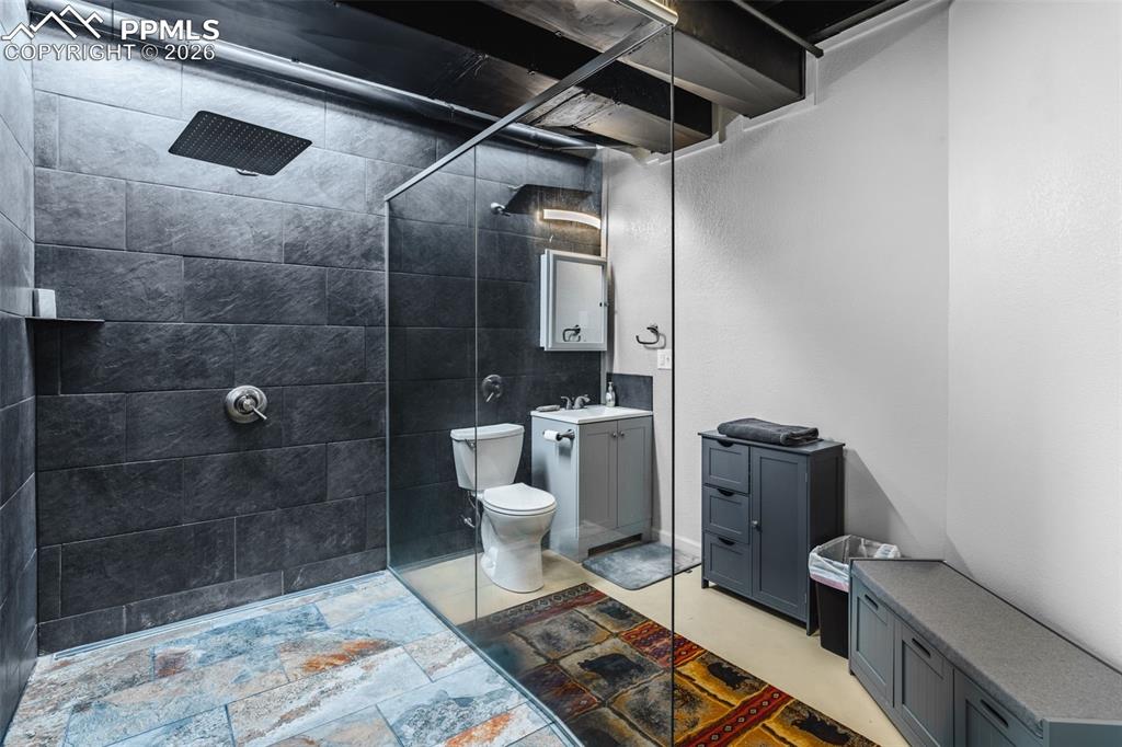 Image 27 of 50: Oversized walk in shower in basement w/ heated fan.