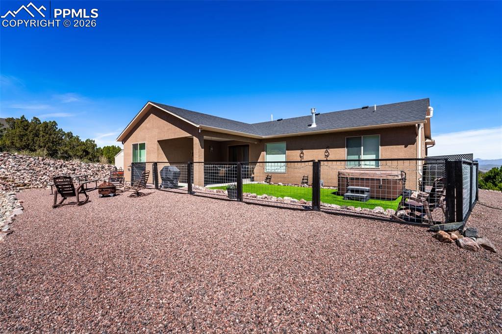 Image 29 of 50: Back of house with a patio and stucco siding
