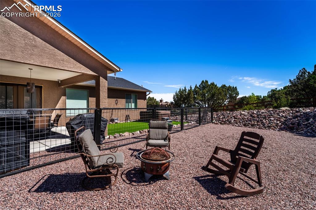 Image 32 of 50: Fire pit behind backyard