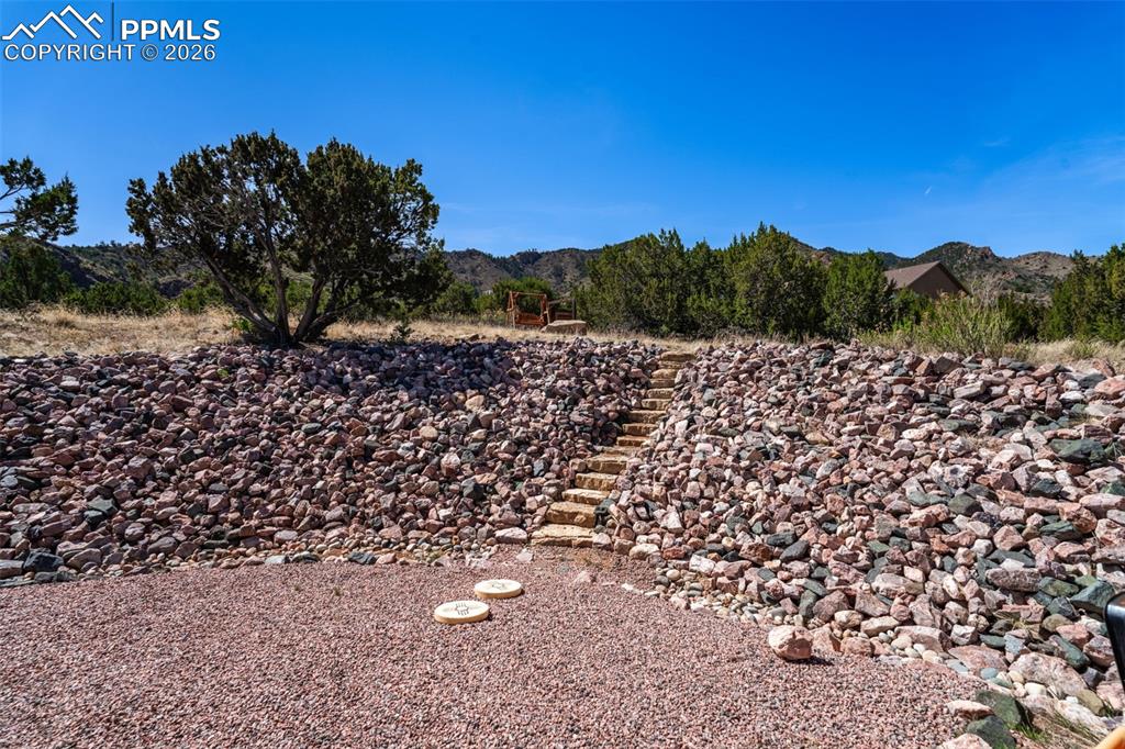 Image 33 of 50: Paved stairs to wooden swing and viewing area