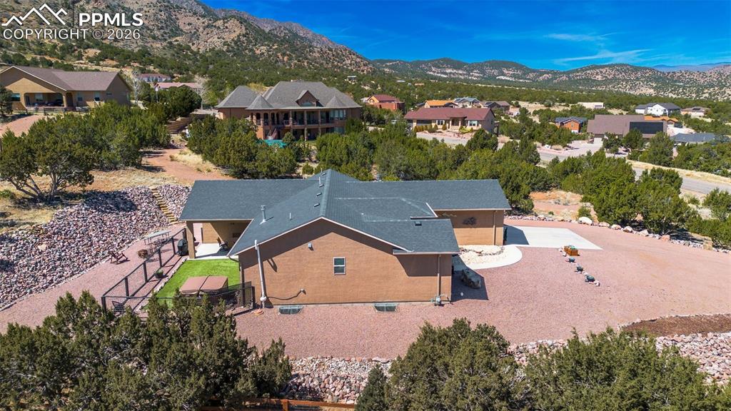 Image 39 of 50: Aerial view of residential area with a mountainous background