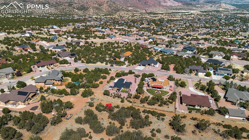 Image 46 of 50: Aerial view of property and surrounding area featuring a mountainous backgr