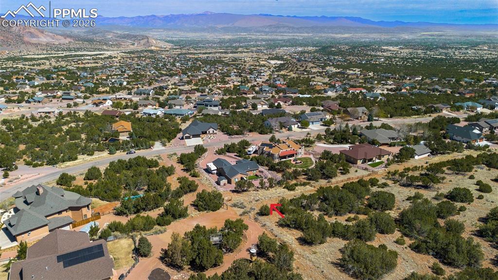 Image 48 of 50: Aerial perspective of suburban area with a mountainous background