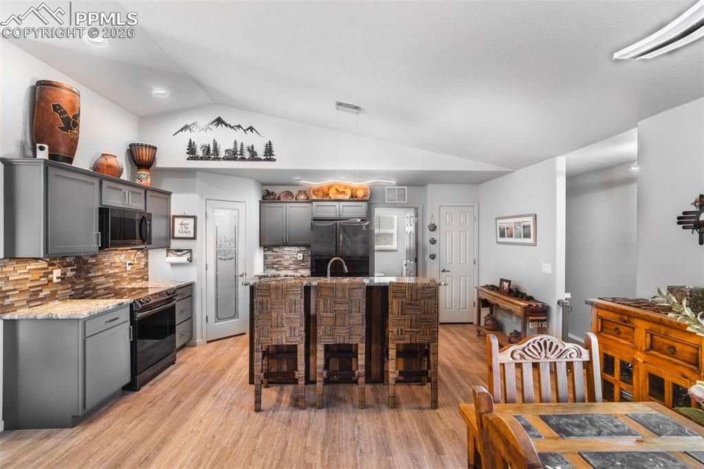 Image 5 of 50: Kitchen with a breakfast bar