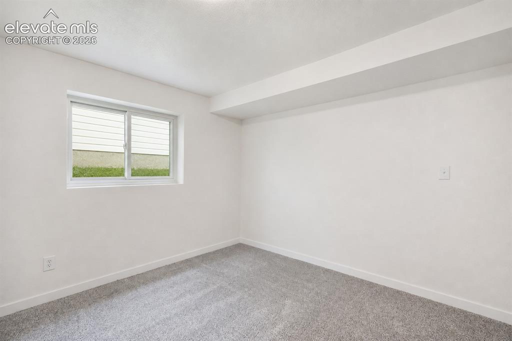 Image 36 of 47: Room featuring light gray carpet, white walls, and a white-framed window