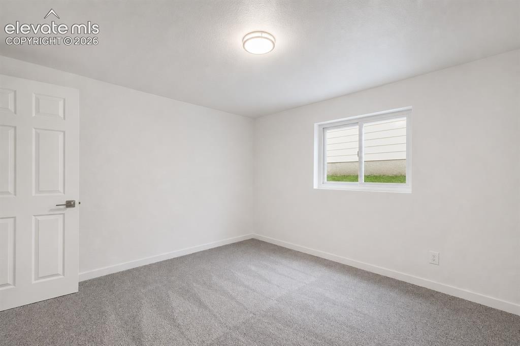 Image 38 of 47: Neutral tone wall paint with a contrasting light gray carpet