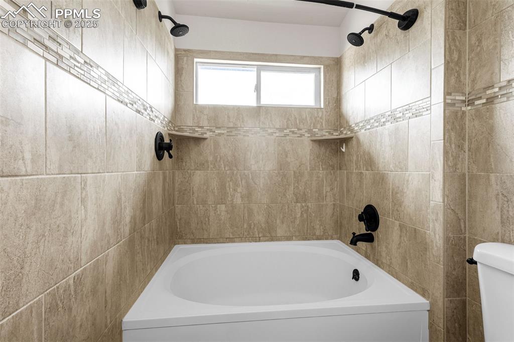 Image 20 of 38: Full bathroom featuring shower / bath combination and toilet