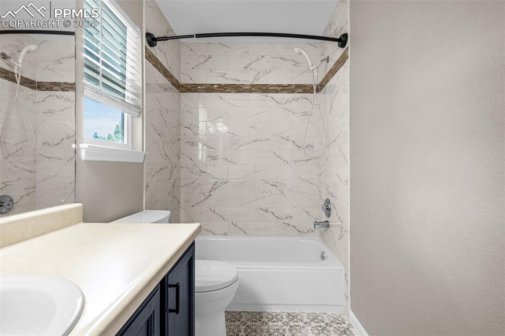 Image 21 of 38: Bathroom with vanity and bathtub / shower combination