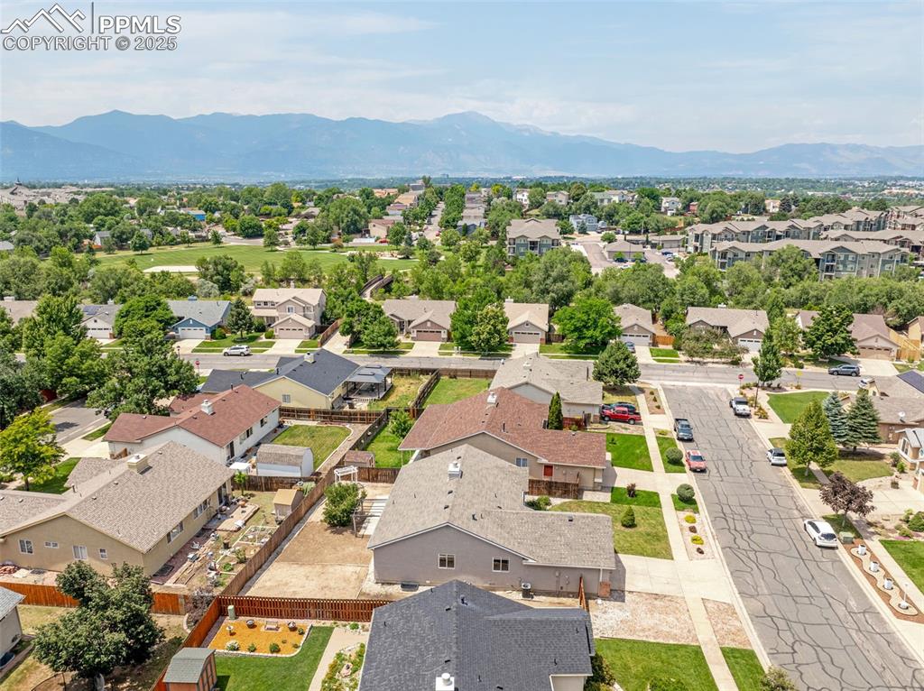 Image 35 of 38: Aerial perspective of suburban area featuring a mountainous background