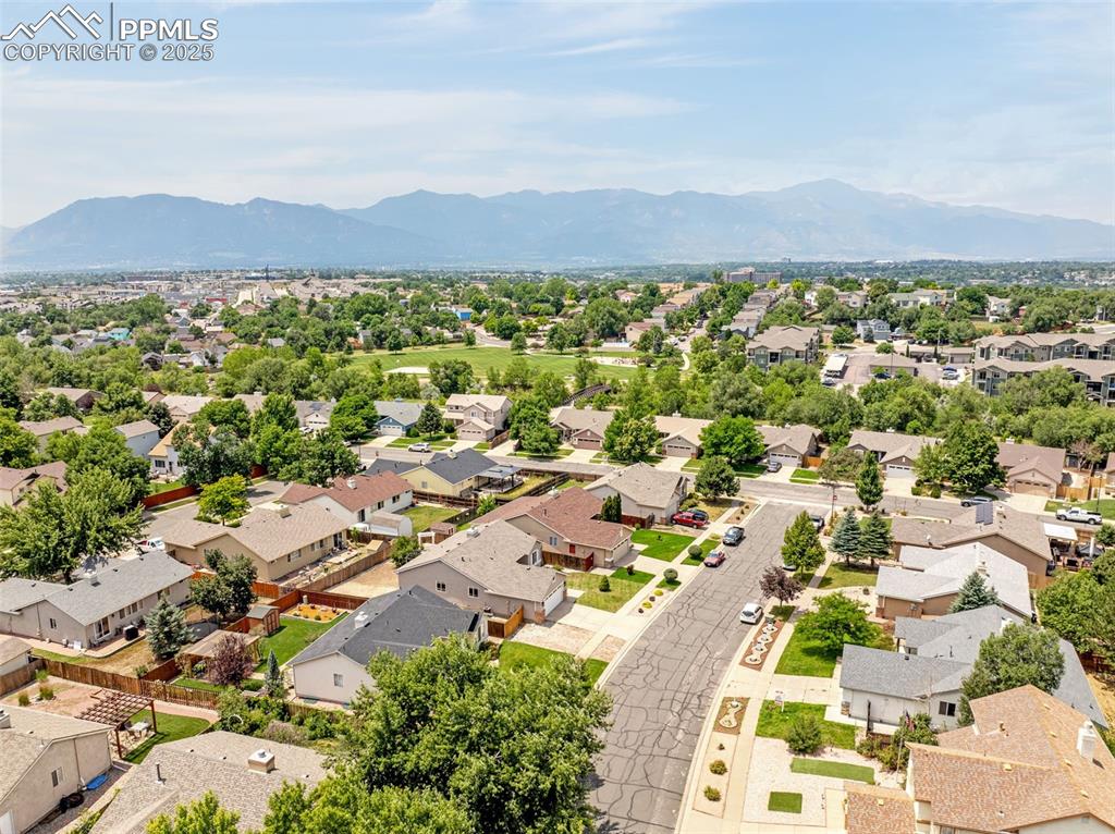 Image 36 of 38: Aerial perspective of suburban area with a mountainous background