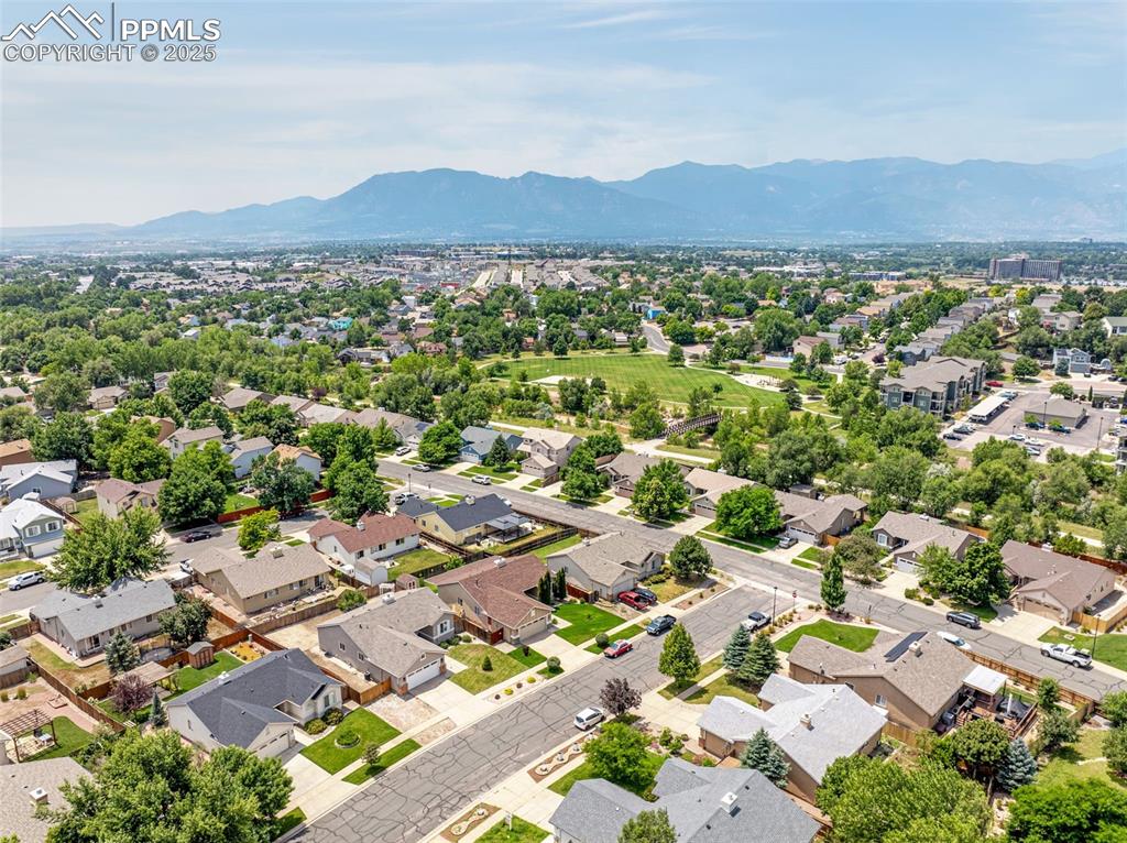Image 37 of 38: Aerial perspective of suburban area with a mountainous background