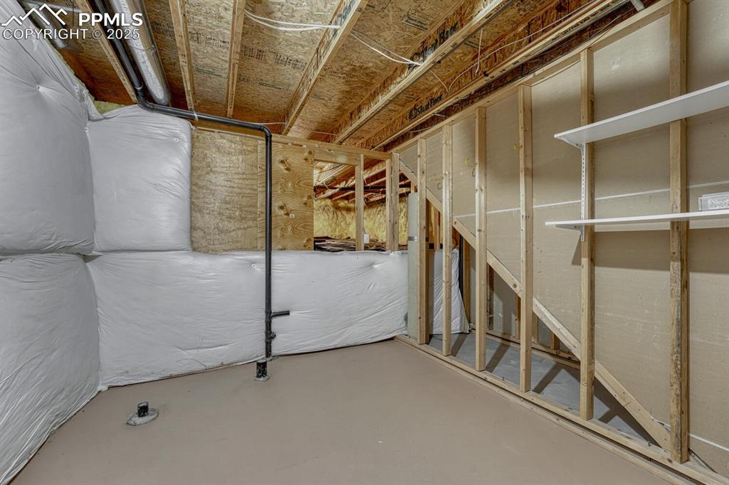 Image 26 of 50: Storage room with plumbing rough-in for future 3rd bathroom