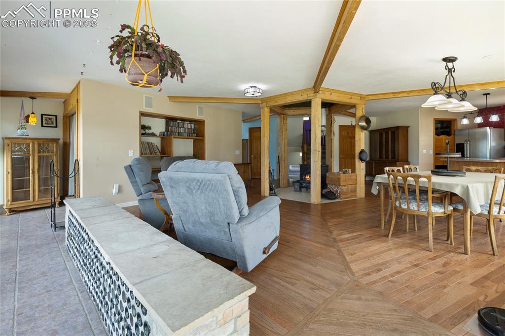 Image 10 of 46: Thermal Mass Wall in the Wrap Around Sunroom makes keeping this home cozy f