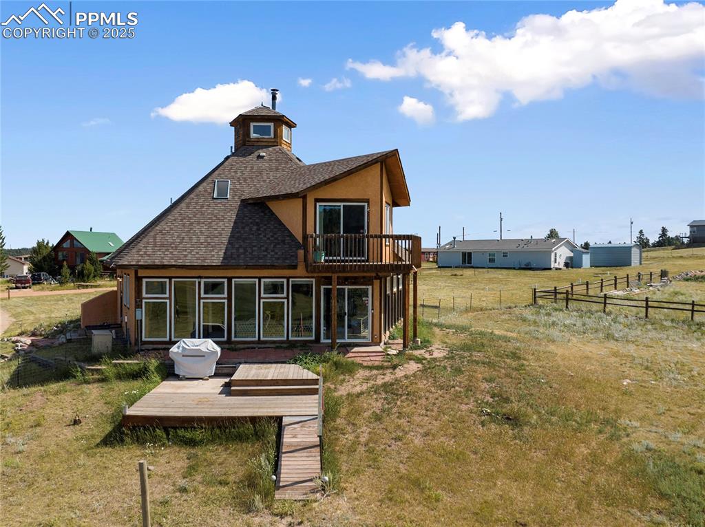 Image 11 of 46: Tiered Deck off the Sunroom and the concrete patio under the grill is wired