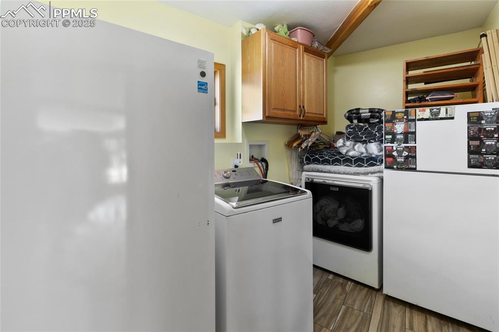 Image 21 of 46: Large Laundry Room. Extra refrigerator and freezer included. Plumbed for a