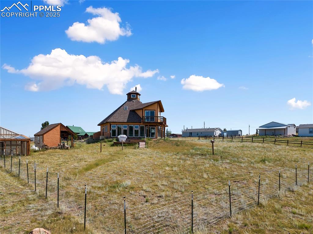 Image 43 of 46: Fenced back yard with no-climb fencing to keep your beloved pets safe. Wea