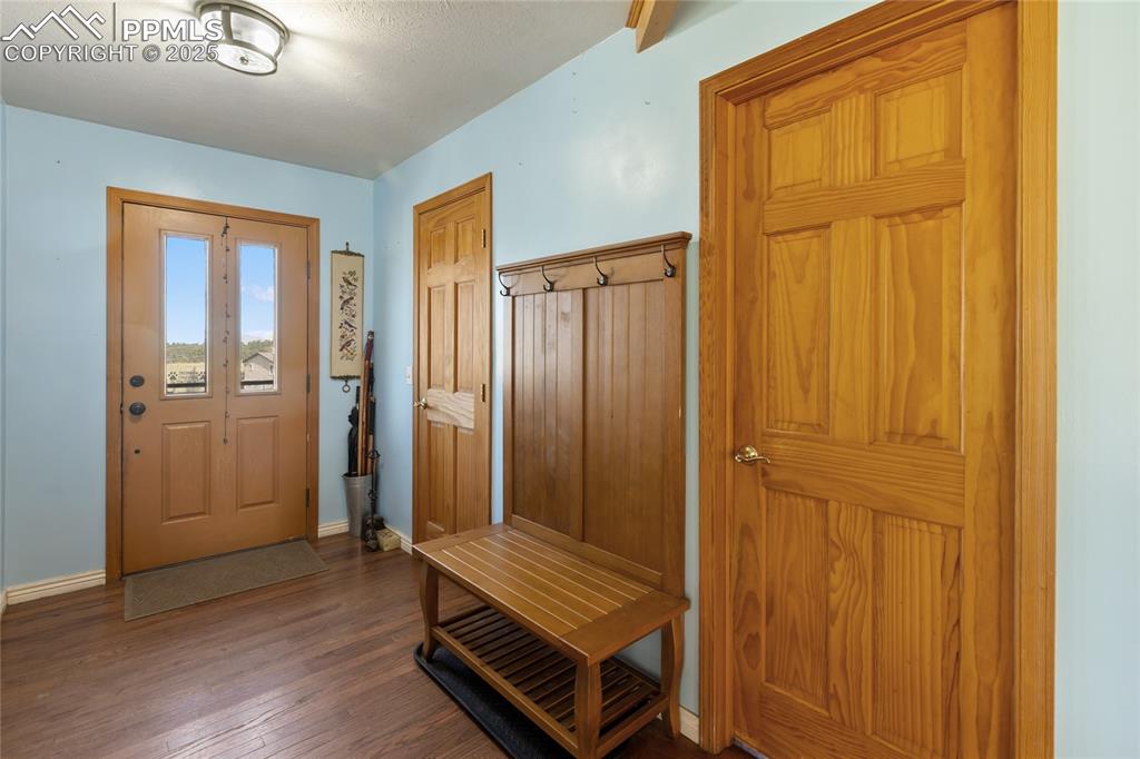 Image 7 of 46: Entry Hall with huge walk-in closet, guest bath and Home Office entry