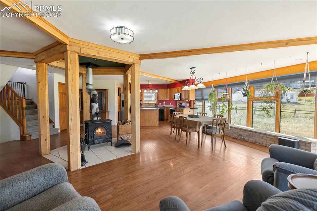 Image 9 of 46: The centrally located Wood Stove is the Heart of this Home and can heat the