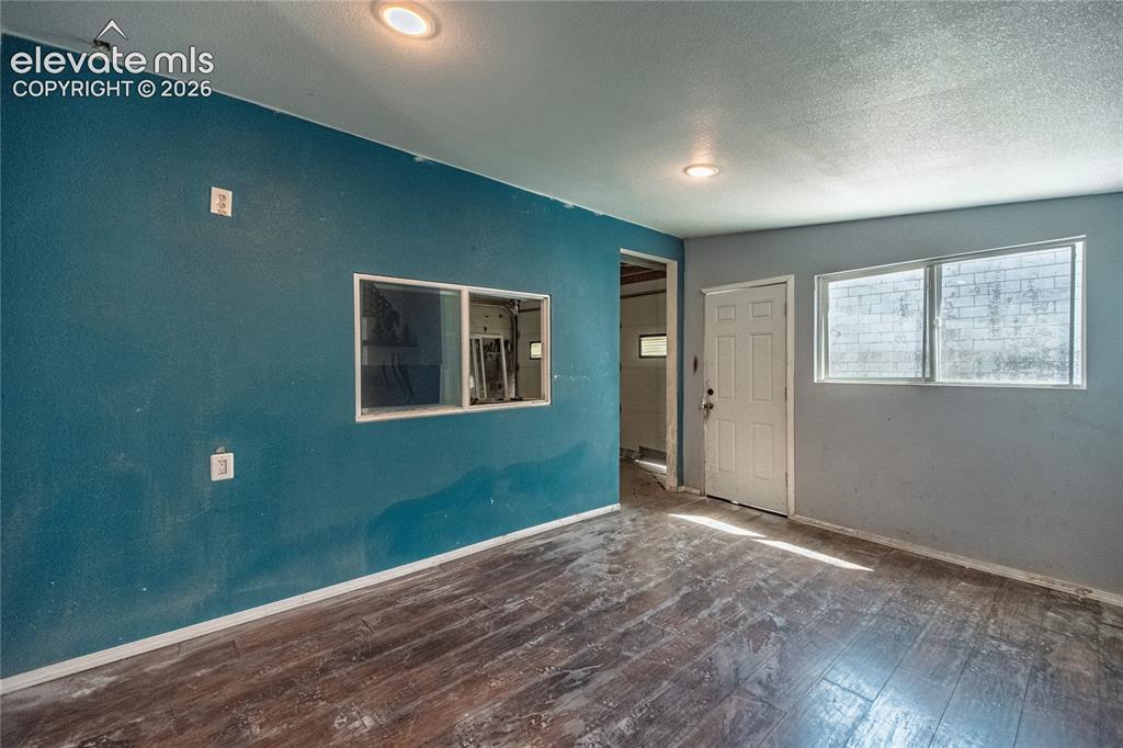 Image 35 of 50: Wood-finish flooring with recessed ceiling lights