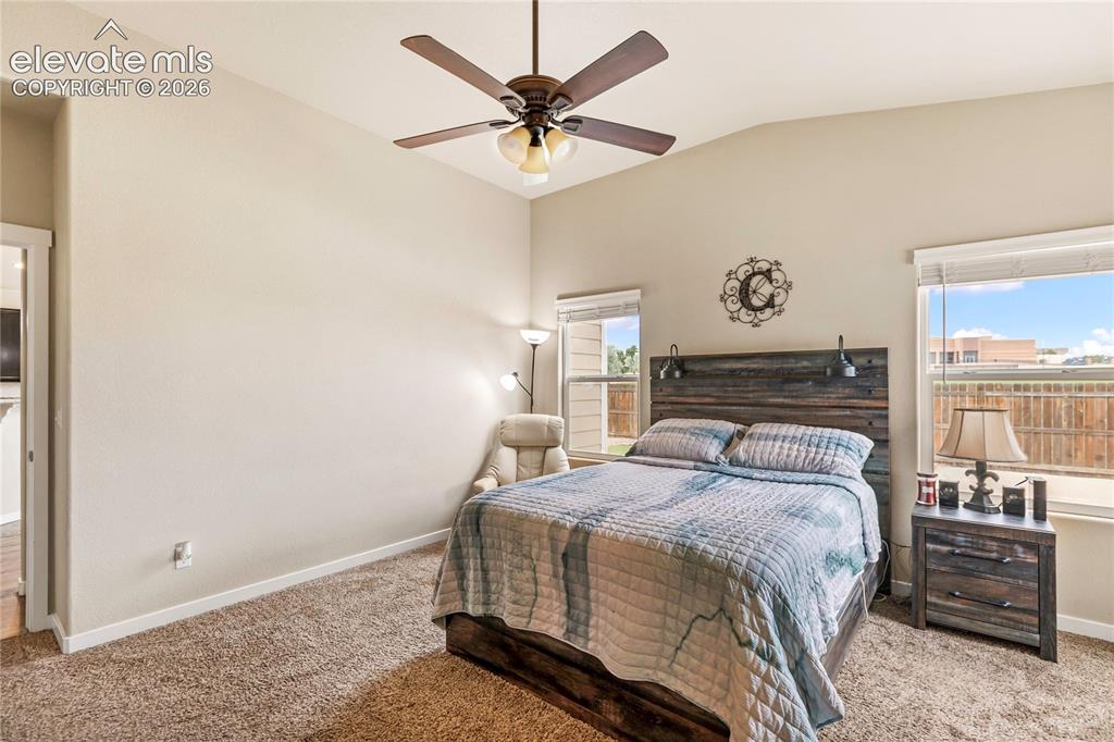 Image 12 of 30: Vaulted primary bedroom offering abundant natural light and a spacious, ope