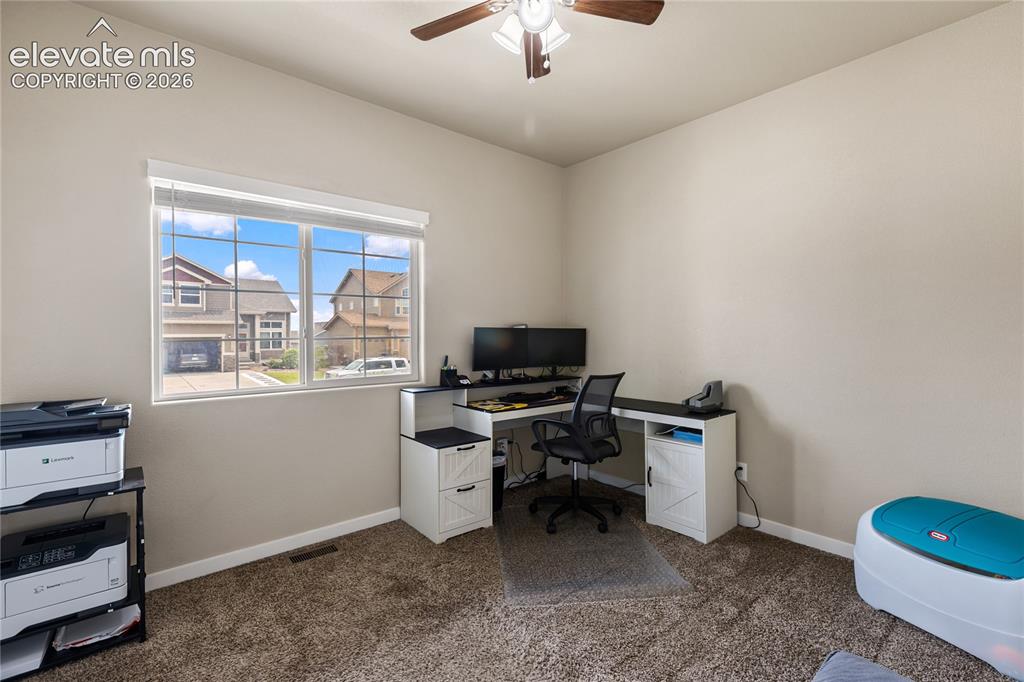 Image 13 of 32: Bedroom currently utilized as a home office