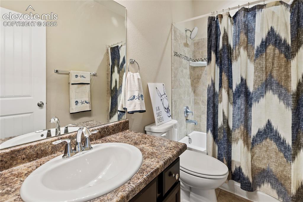 Image 15 of 32: Bathroom vanity featuring an oval undermount sink with a chrome faucet, set