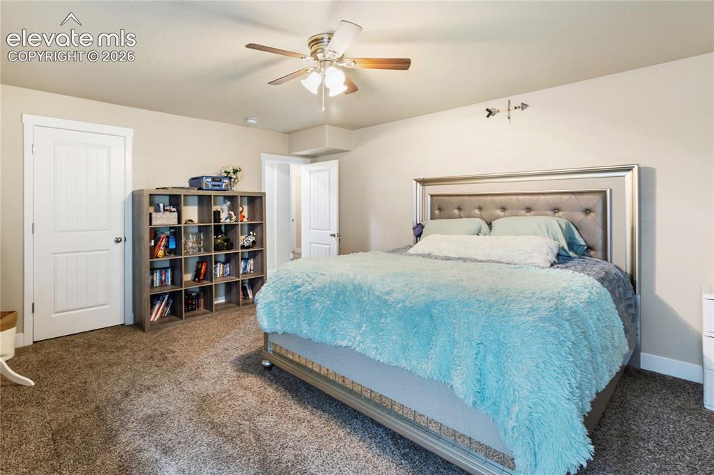 Image 22 of 32: Carpeted room featuring a ceiling fan with light fixture, recessed ceiling