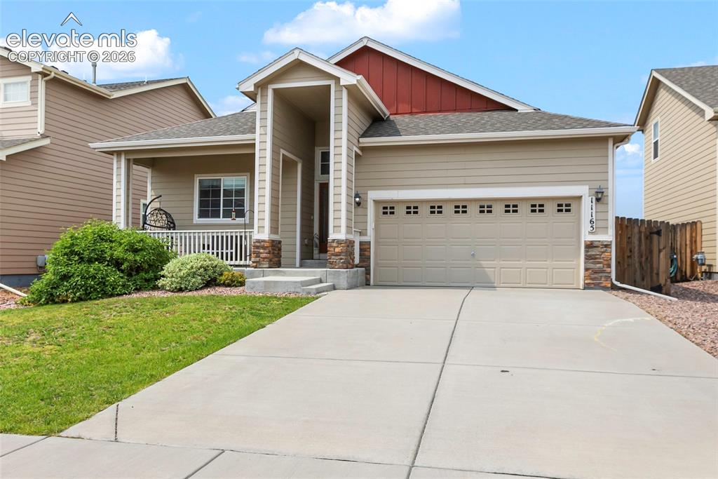 Image 26 of 32: Contemporary residence featuring a covered front porch with white railing,