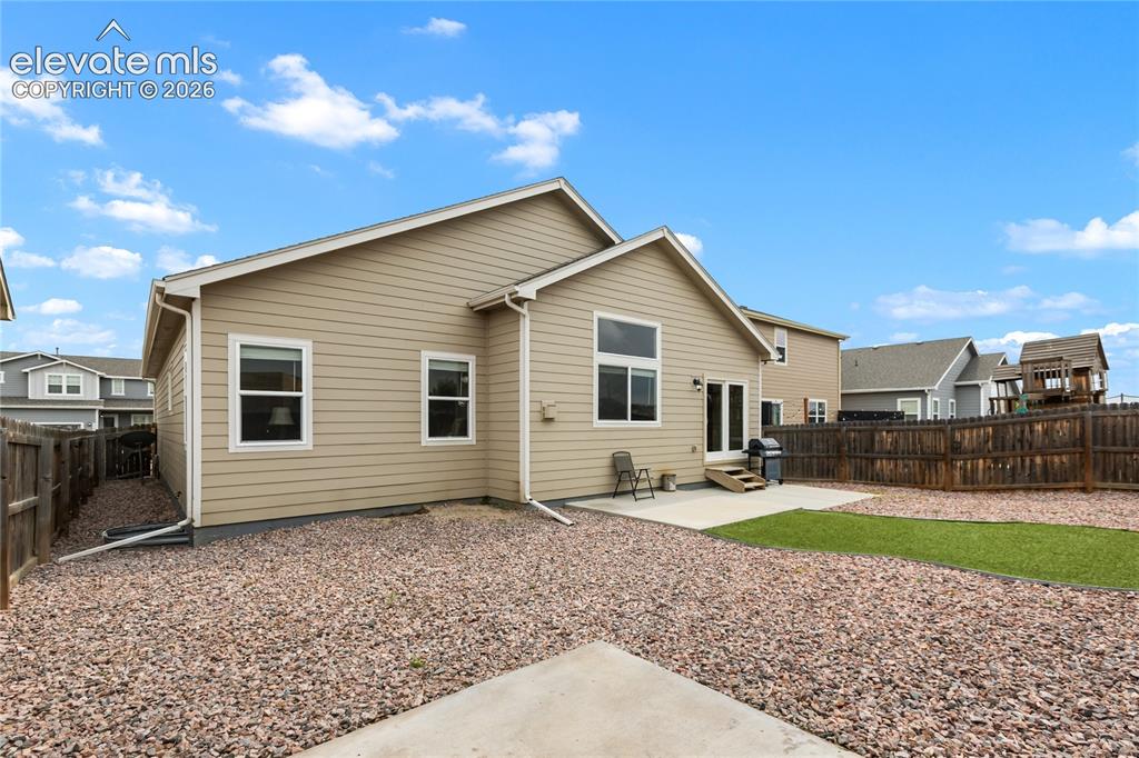 Image 27 of 32: Private backyard featuring a full perimeter privacy fence