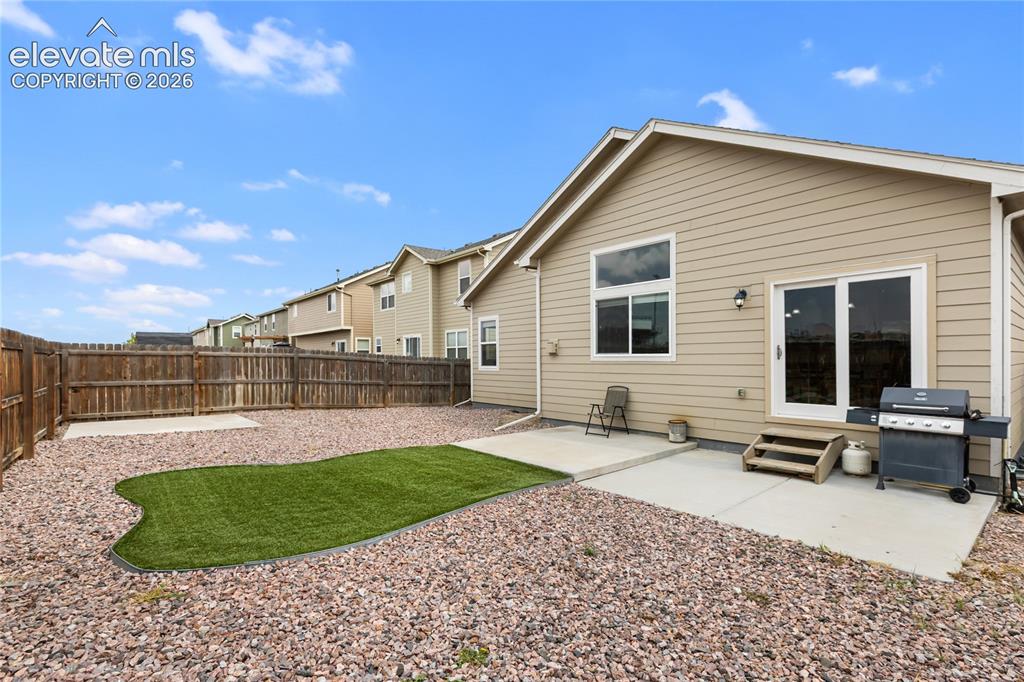 Image 28 of 32: Private backyard featuring a full perimeter privacy fence