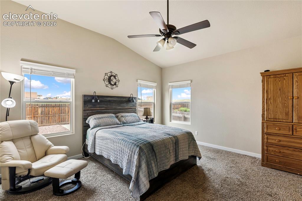 Image 7 of 32: Vaulted primary bedroom offering abundant natural light and a spacious, ope