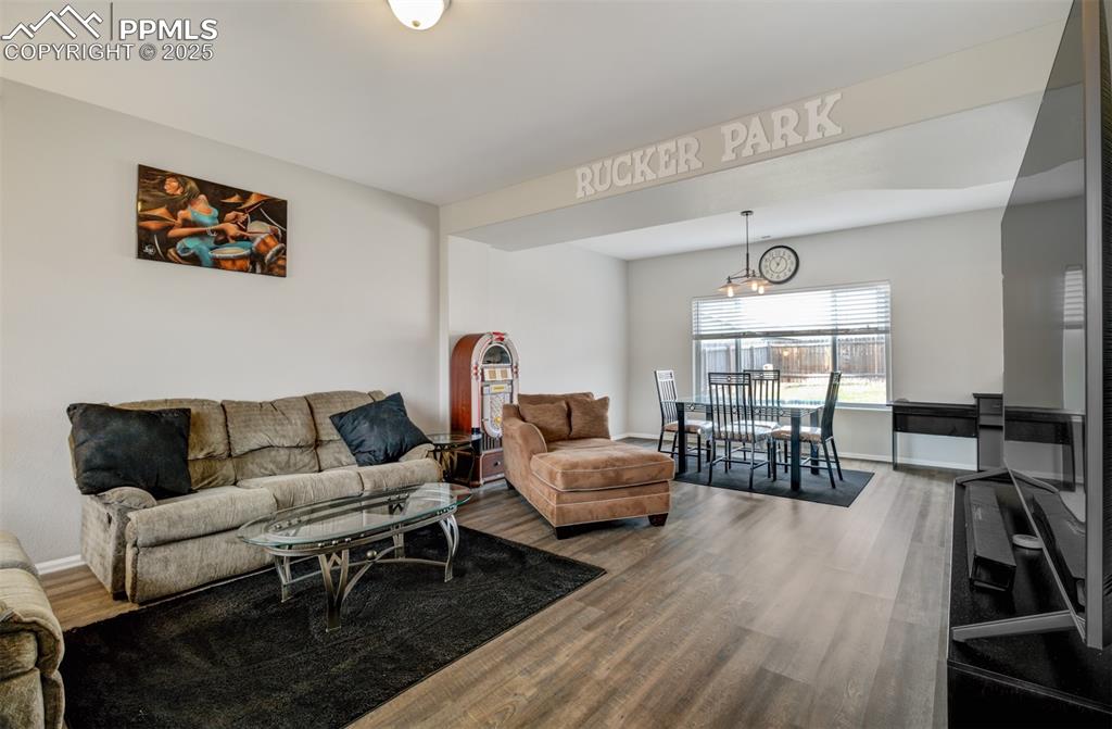 Image 11 of 35: Living area featuring baseboards and wood finished floors