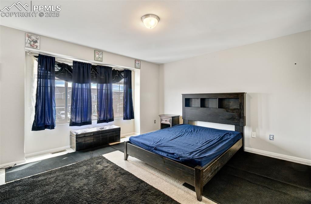 Image 13 of 35: Carpeted bedroom with baseboards, visible vents, and billiards