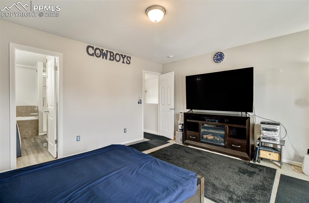 Image 14 of 35: Bedroom featuring baseboards, carpet flooring, and connected bathroom