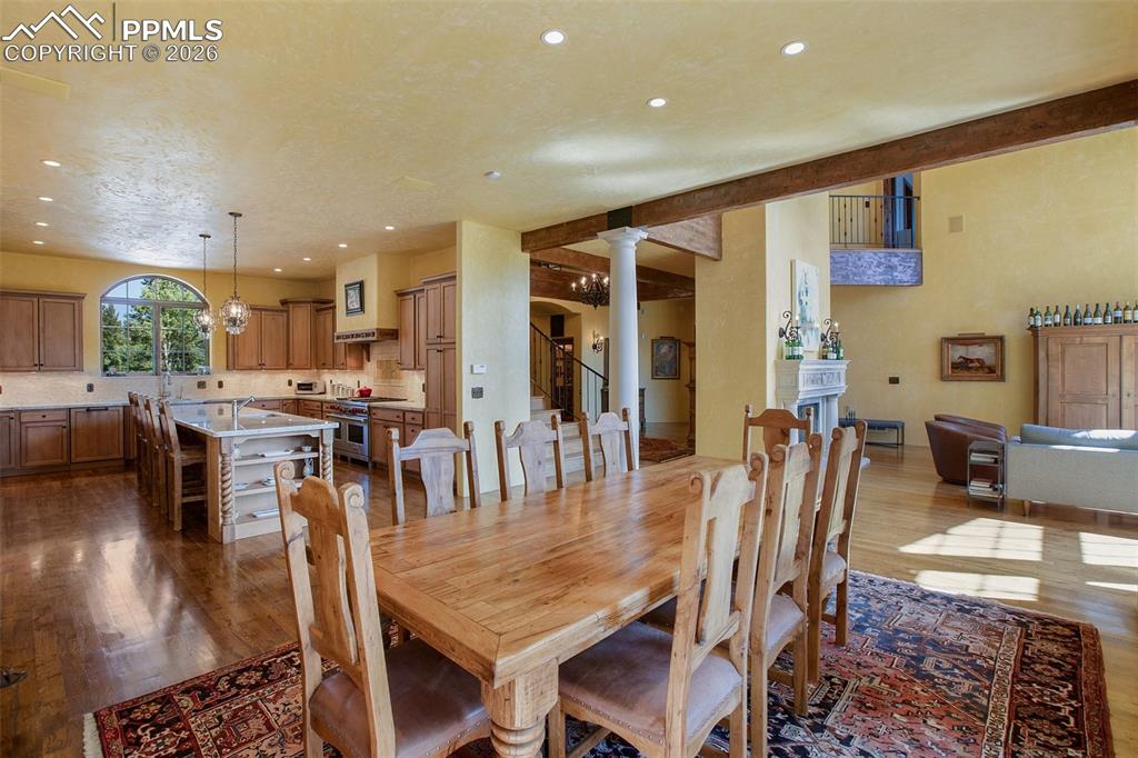 Image 16 of 50: Dining area looking into the adjacent gourmet kitchen, entry/staircase, and