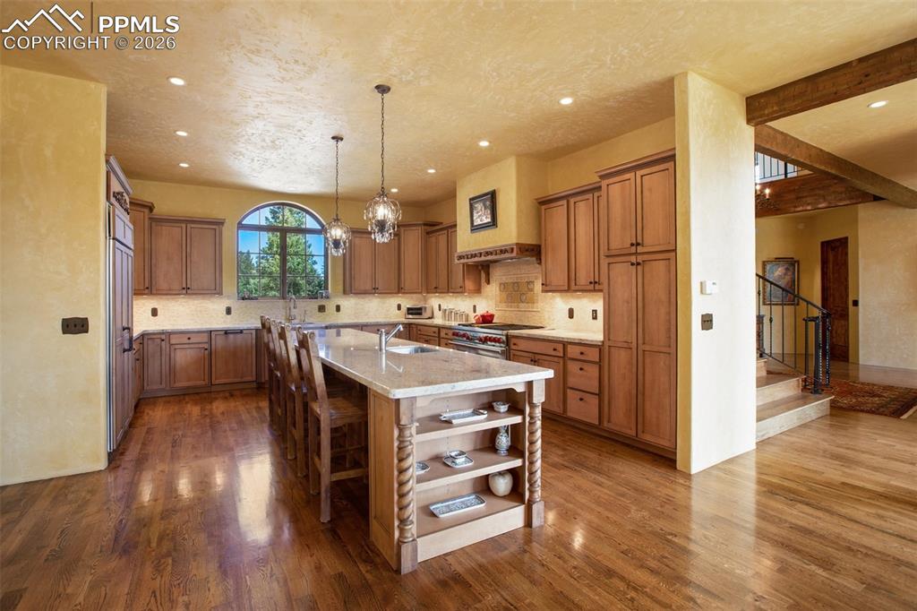 Image 18 of 50: An alternate view into the kitchen featuring the huge island with prep sink