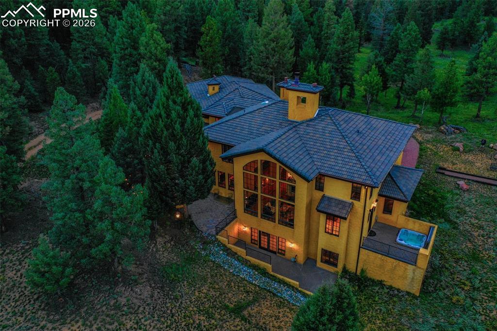 Image 2 of 50: Aerial view at dusk of the back of the structure.