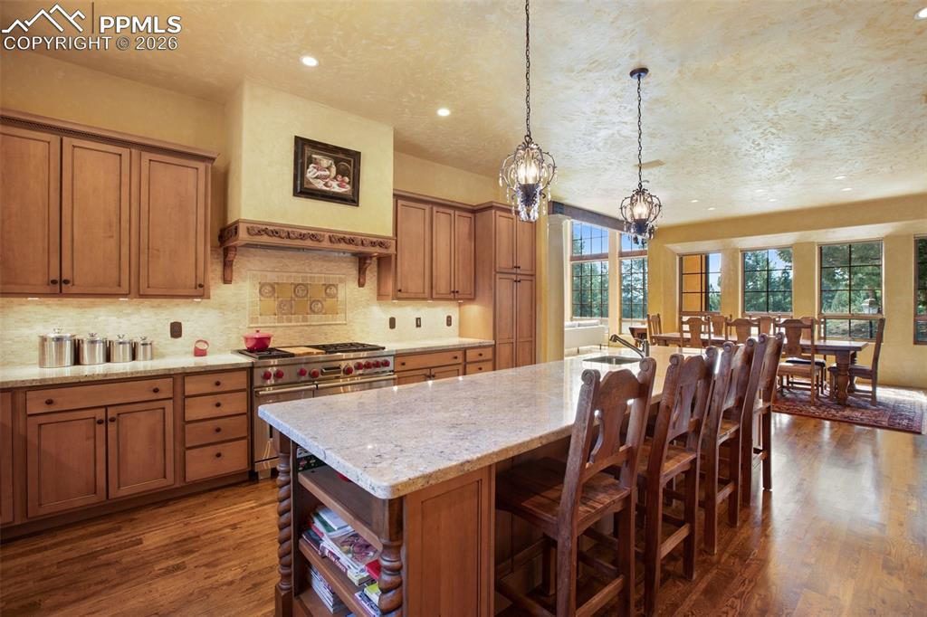 Image 20 of 50: Another view of the kitchen 48" Wolf Gas Range with double ovens and approp